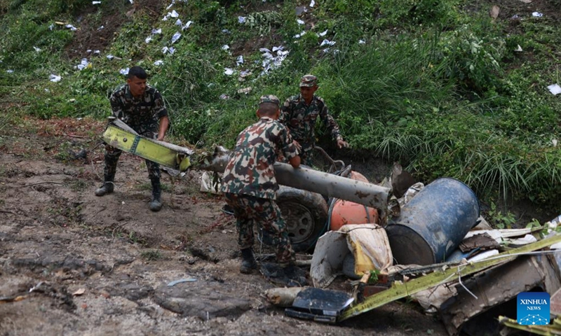 Rescuers collect debris at the site of an air crash at the Tribhuvan International Airport in Kathmandu, Nepal, July 24, 2024. Eighteen dead bodies have been recovered after a plane crashed on Wednesday at the Tribhuvan International Airport in Kathmandu, Nepal's capital, said Hansa Raj Pandey, spokesman at the Civil Aviation Authority of Nepal (CAAN). (Photo: Xinhua)