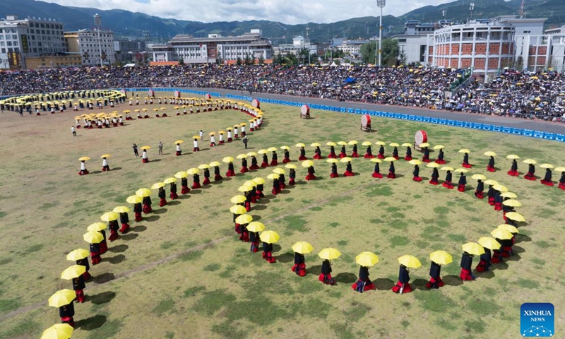 People perform during the torch festival in Butuo County of Liangshan Yi Autonomous Prefecture, southwest China's Sichuan Province, July 22, 2024. A traditional torch festival of Yi ethnic group was staged from July 21 to 24 here, which featured various activities including costume displays, campfire party, traditional ethnic sports events, dancing and traditional beauty contest to attract visitors from across the country.(Photo: Xinhua)