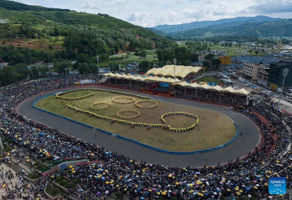 An aerial drone photo taken on July 22, 2024 shows people performing during the torch festival in Butuo County of Liangshan Yi Autonomous Prefecture, southwest China's Sichuan Province. A traditional torch festival of Yi ethnic group was staged from July 21 to 24 here, which featured various activities including costume displays, campfire party, traditional ethnic sports events, dancing and traditional beauty contest to attract visitors from across the country. (Photo: Xinhua)