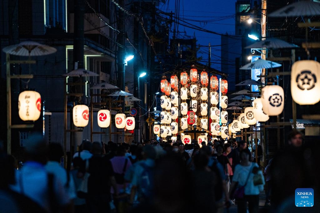 People watch a float illuminated by lanterns during the Gion Festival in Kyoto, Japan, on July 23, 2024. The Gion Festival, which lasts throughout the entire month of July, is an annual traditional festival in Kyoto. It originated in 869 when a plague broke out in Kyoto. To pray for peace and the elimination of the disease, a grand festival was held. This festival gradually evolved into an annual fixed event and has continued to this day. (Photo: Xinhua)