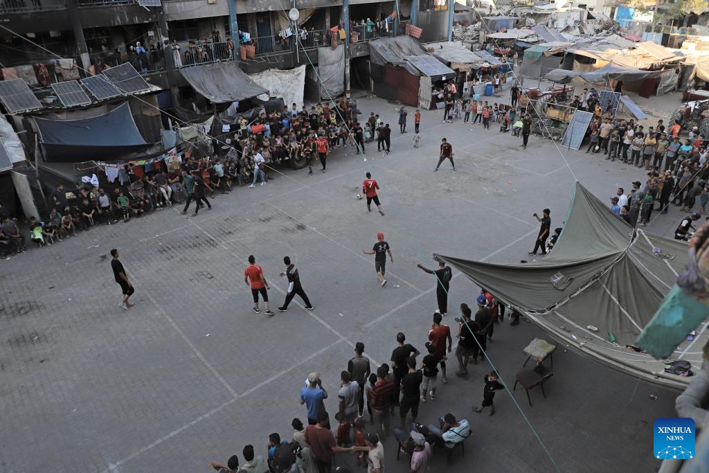 This photo taken on July 23, 2024 shows people playing a football game in Jabalia refugee camp, northern Gaza Strip. (Photo: Xinhua)