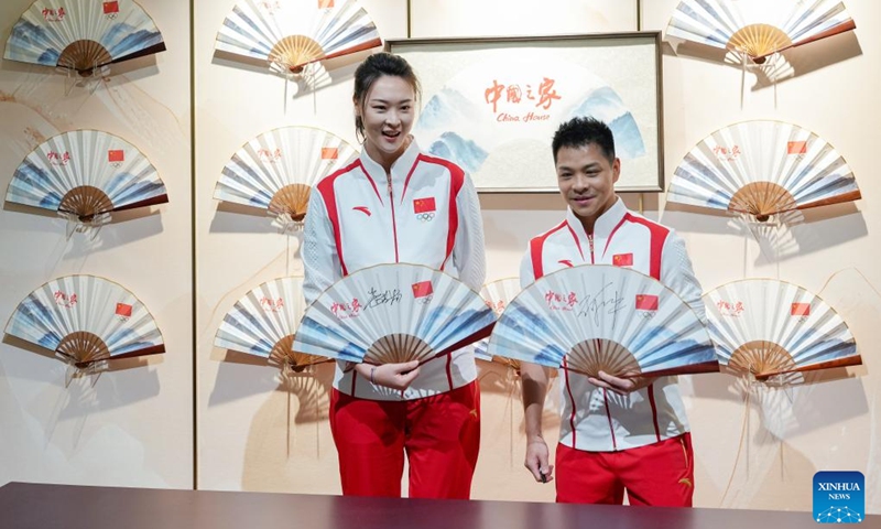 Hui Ruoqi (L), Olympic champion and former captain of the Chinese volleyball team, and He Chong, Olympic diving champion, pose for photos at the China House in Paris, France, on July 24, 2024. The China House for the Paris 2024 Olympic Games was inaugurated at the Hotel Salomon de Rothschild in Paris on Wednesday. Photo: Xinhua