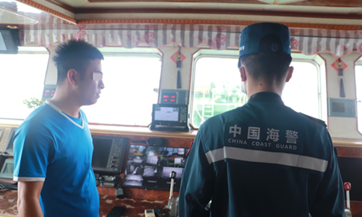 China Coast Guard (CCG) officers board fishing boats to inspect fishing nets and gear. Photo: CCG