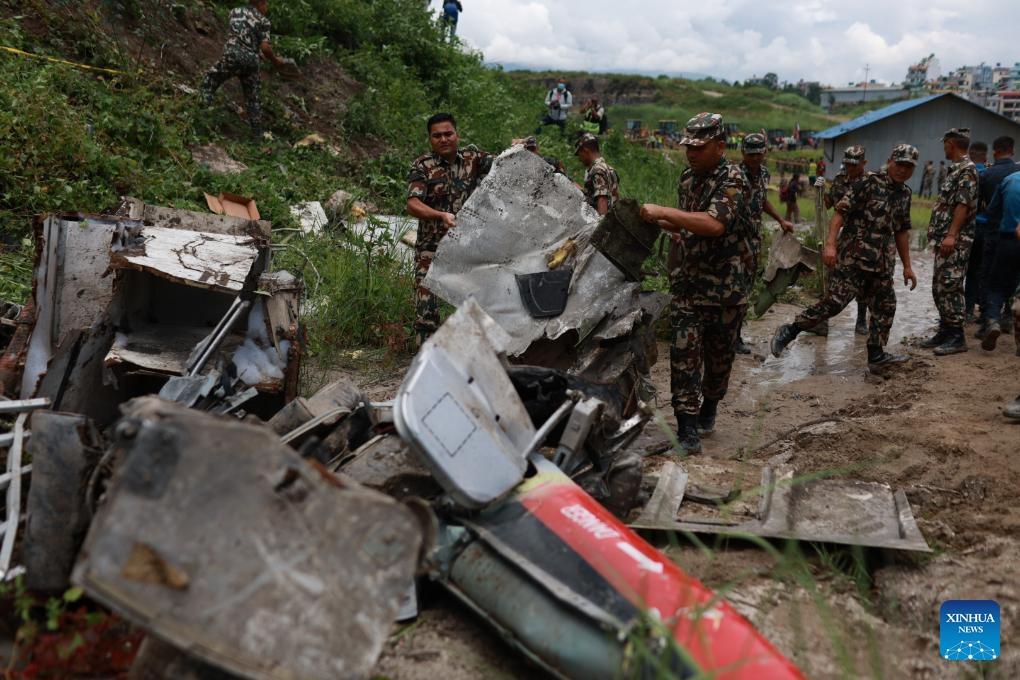 Rescuers collect debris at the site of an air crash at the Tribhuvan International Airport in Kathmandu, Nepal, July 24, 2024. Eighteen dead bodies have been recovered after a plane crashed on Wednesday at the Tribhuvan International Airport in Kathmandu, Nepal's capital, said Hansa Raj Pandey, spokesman at the Civil Aviation Authority of Nepal (CAAN). (Photo: Xinhua)