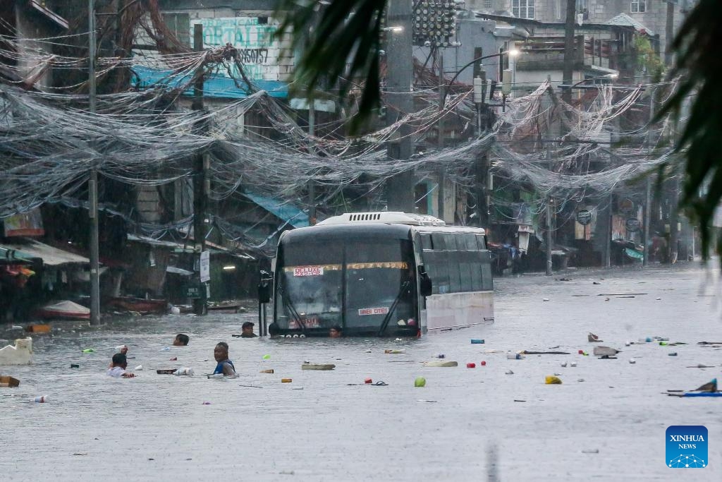 A bus is submerged in flood due to heavy rain in Quezon City, the Philippines, on July 24, 2024. The Philippines has been buffeted by non-stop rains from the enhanced southwest monsoon brought by Typhoon Gaemi, which caused the Metro Manila Council to declare a state of calamity in National Capital Region on Wednesday. (Photo: Xinhua)