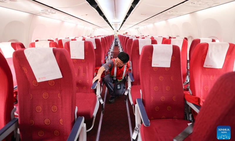 A staff member checks life jacket readiness at the cabin of an airplane at Meilan International Airport in Haikou, south China's Hainan Province, July 23, 2024. The Meilan International Airport has seen a constant increase in its passenger flow since the beginning of this summer. Staff members of HNA (Hainan Airline) Technic manage to ensure flight safety with thorough maintenance checkups during the peak season. (Photo: Xinhua)