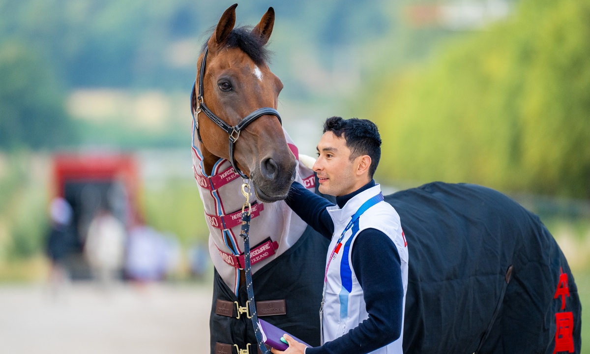 Hua Tian with his horse Chocs Photo: Courtesy of the International Federation for Equestrian Sports