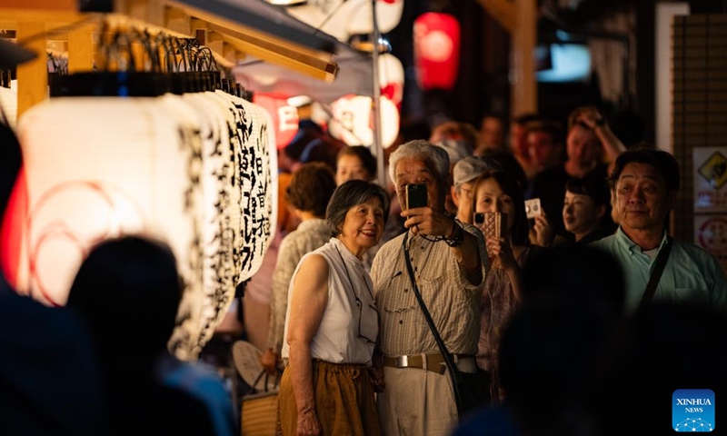 People take photos with a float during the Gion Festival in Kyoto, Japan, on July 23, 2024. The Gion Festival, which lasts throughout the entire month of July, is an annual traditional festival in Kyoto. It originated in 869 when a plague broke out in Kyoto. To pray for peace and the elimination of the disease, a grand festival was held. This festival gradually evolved into an annual fixed event and has continued to this day. (Photo: Xinhua)