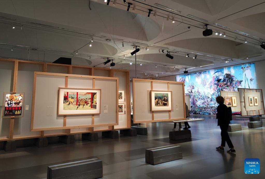 A visitor walks past artworks during an exhibition on the Japanese pop culture tradition at National Gallery of Art in Vilnius, Lithuania, on July 24, 2024. Titled Beauties, Ghosts, and Samurai--The Japanese Pop Culture Tradition from Edo Ukiyo-e to Manga, Anime, and Supa Furatto in the 20th and 21st Centuries, the exhibition is held here from July 19 to Oct. 13, presenting works of more than 70 artists. (Photo: Xinhua)