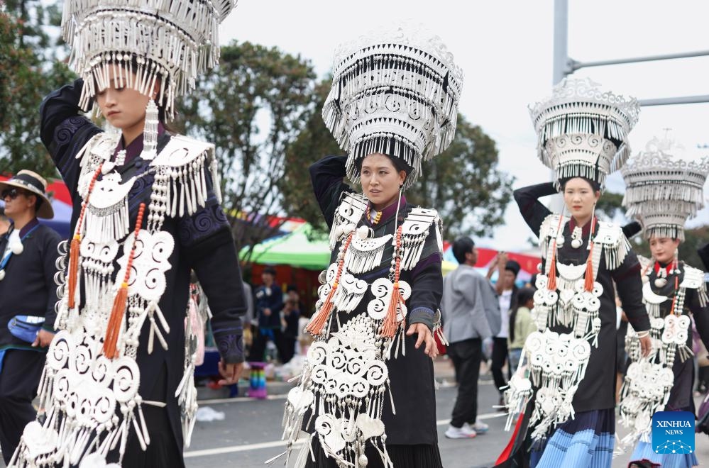 Local people dressed in traditional Yi costumes walk on a street in Butuo County of Liangshan Yi Autonomous Prefecture, southwest China's Sichuan Province, July 22, 2024. Residents in traditional costumes of Yi ethnic group participated in the four-day torch festival staged from July 21 to 24. (Photo: Xinhua)