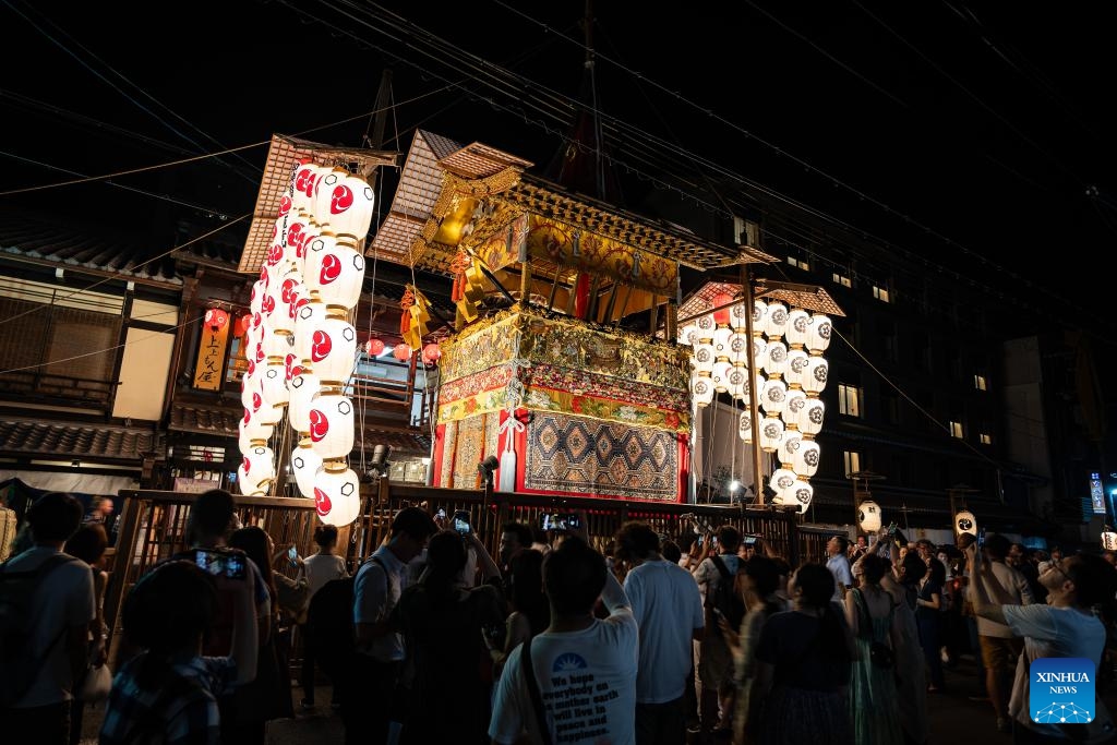 People watch a float illuminated by lanterns during the Gion Festival in Kyoto, Japan, on July 23, 2024. The Gion Festival, which lasts throughout the entire month of July, is an annual traditional festival in Kyoto. It originated in 869 when a plague broke out in Kyoto. To pray for peace and the elimination of the disease, a grand festival was held. This festival gradually evolved into an annual fixed event and has continued to this day. (Photo: Xinhua)