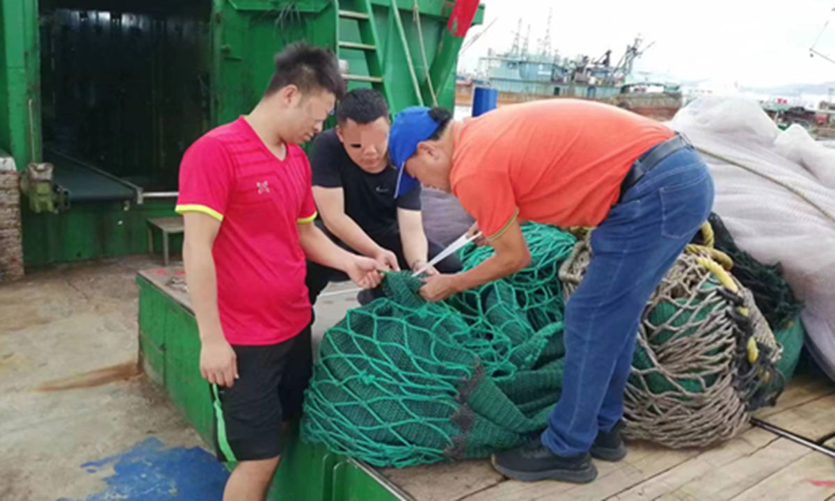 China Coast Guard (CCG) officers board fishing boats to inspect fishing nets and gear. Photo: CCG