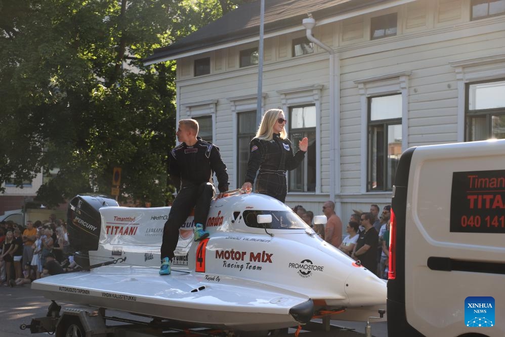 Two racers and their powerboat are pictured during the Maritime Festival parade in Kotka, Finland, July 24, 2024. The four-day festival kicked off here on Wednesday. (Photo: Xinhua)