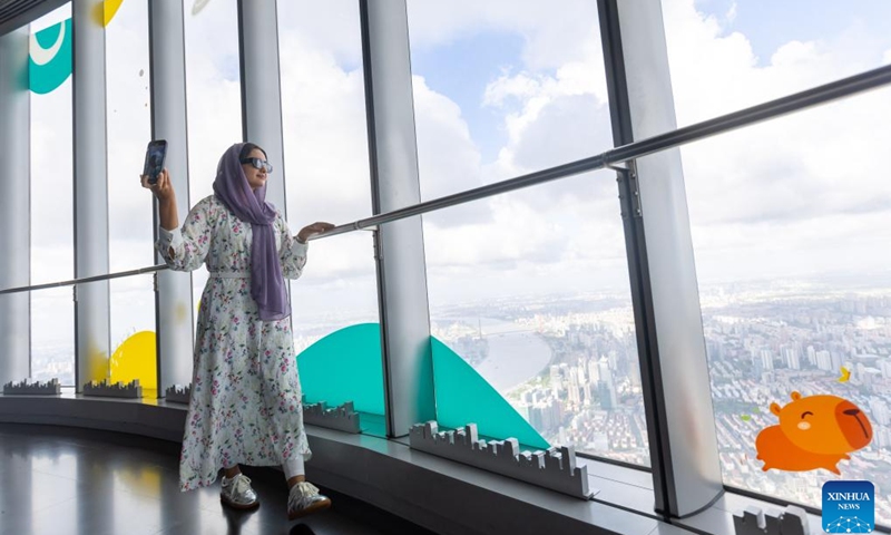 An internet celebrity takes a selfie on the sightseeing floor of Shanghai Tower in east China's Shanghai, July 24, 2024. Internet celebrities from 21 countries as Brazil, India, Malaysia and Mexico, came to Shanghai for a visit where they can witness the daily lives in China. (Photo: Xinhua)