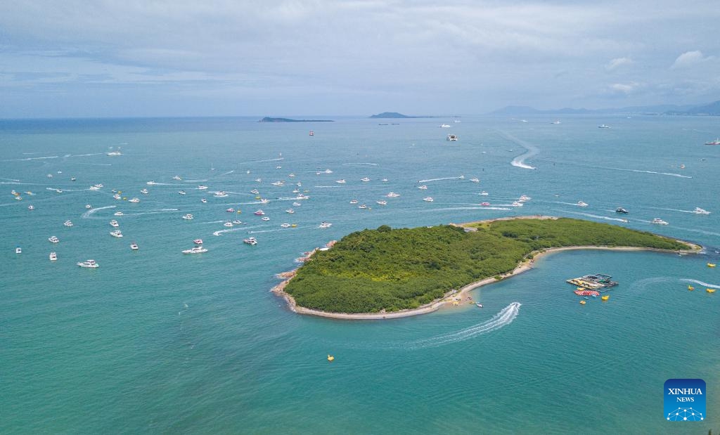 An aerial drone photo taken on July 23, 2024 shows tourists taking yachts in Sanya, south China's Hainan Province. Sanya, a popular tourist spot in the southern island province of Hainan, boasts excellent natural beauty. (Photo: Xinhua)