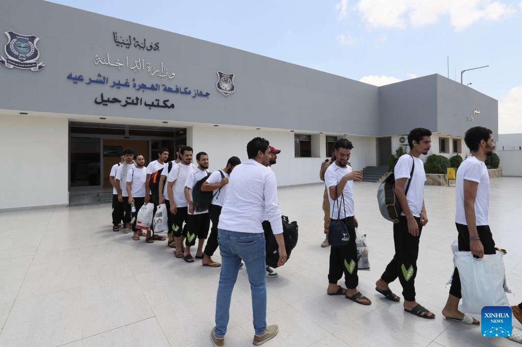 Migrants leave the Deportation Office of the Libyan Illegal Immigration Control Department in Tripoli, Libya, on July 25, 2024. The Illegal Migration Control Department of Libya on Thursday deported more than 700 illegal migrants to their home countries of Niger and Egypt, an official told Xinhua. (Photo: Xinhua)