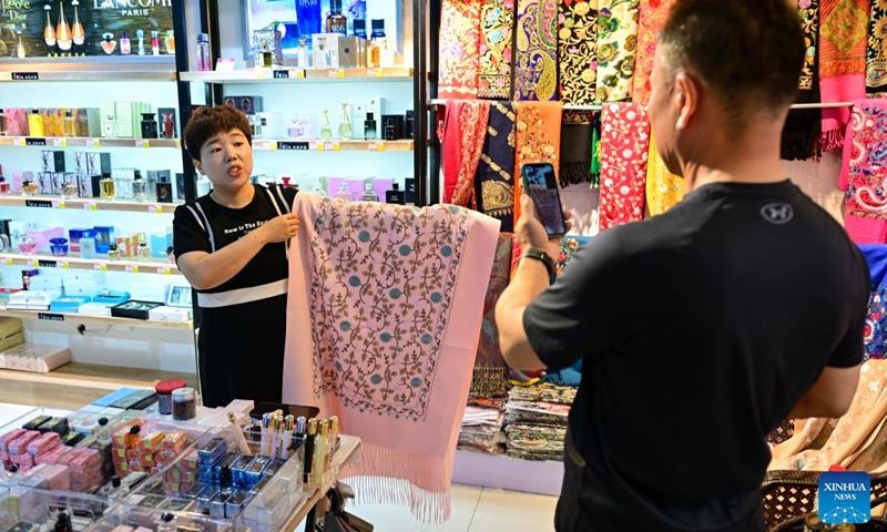 A tourist visits a duty-free shop at the Horgos International Border Cooperation Center on the China-Kazakhstan border in Horgos, northwest China's Xinjiang Uygur Autonomous Region, July 26, 2024. Since the implementation of mutual visa exemption between Kazakhstan and China in November 2023, Horgos Port has witnessed a substantial increase of entry and exit tourist trips. In recent days, the Horgos International Border Cooperation Center on the China-Kazakhstan border has ushered in the peak of border tourism. Photo: Xinhua