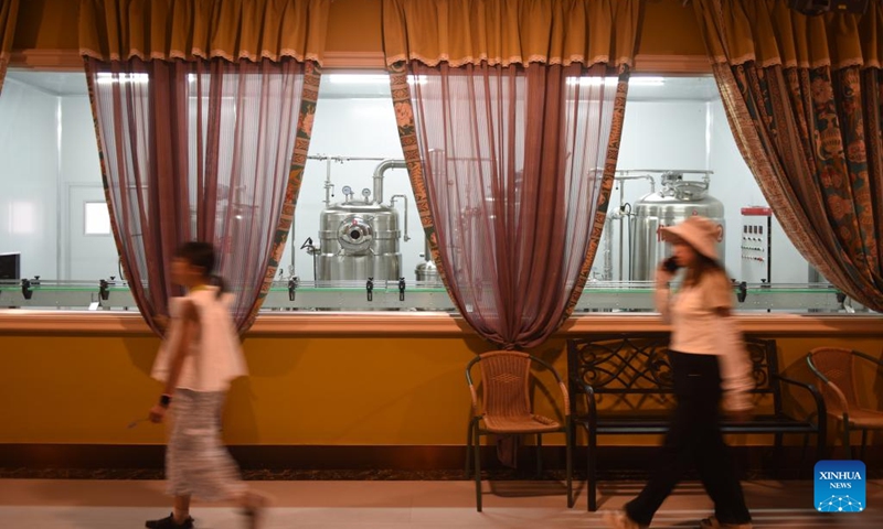 Tourists walk past a lavender processing workshop at a lavender museum in Huocheng County, northwest China's Xinjiang Uygur Autonomous Region, July 26, 2024. Lavender was introduced in Huocheng County more than half century ago from France. Sharing many similarities with Provence in France as latitude, meteorological and soil conditions, Huocheng become the largest lavender production base in China and the third largest in the world, following Provence and Japan's Furano. Photo: Xinhua