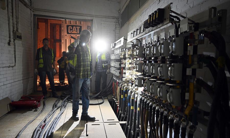 A worker maintains one of the power generators that went out of service in Hawalli Governorate, Kuwait, on June 19, 2024. Multiple areas in Kuwait faced power cuts on Wednesday as scorching temperatures pushed the electricity grid to its limits during peak hours. Photo: Xinhua