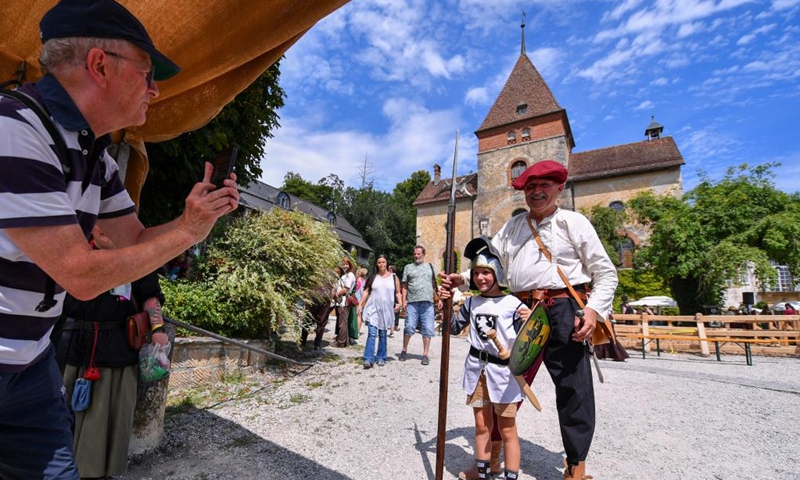 People in folk costumes pose for photos during the folk festival Mittelalter-Spektakel at Munchenwiler Castle in the Lake Murten region in Switzerland, July 27, 2024. The folk festival was held from Friday to Sunday at Munchenwiler Castle. Various activities, fairs, and folk performances featuring the Middle Ages were organized during the festival. Photo: Xinhua