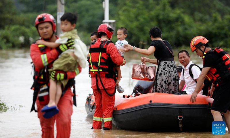 Rescuers relocate residents at Jingtang Village of Zixing City, central China's Hunan Province, July 28, 2024. The residual winds from Typhoon Gaemi continue to bring heavy rains to many places in Hunan Province, and local authorities are actively carrying out rescue and relief work. Photo: Xinhua