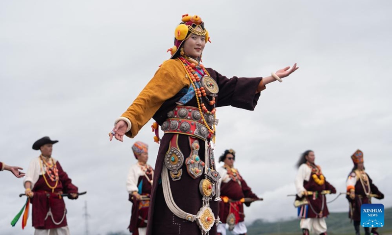 Local people display traditional costumes on a grassland in Baiyu County, Garze Tibetan Autonomous Prefecture, southwest China's Sichuan Province, July 27, 2024. A rural folk event kicked off here on Saturday, consisting of performances, milking competition, yak beauty contest, horse racing and other activities. Photo: Xinhua