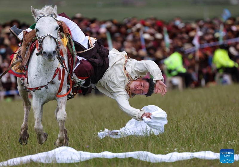 A man participates in a competition of picking up hada on horseback on a grassland in Baiyu County, Garze Tibetan Autonomous Prefecture, southwest China's Sichuan Province, July 28, 2024. Photo: Xinhua