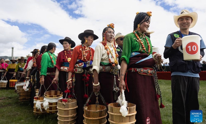 Locals participate in a milking competition on a grassland in Baiyu County, Garze Tibetan Autonomous Prefecture, southwest China's Sichuan Province, July 27, 2024. A rural folk event kicked off here on Saturday, consisting of performances, milking competition, yak beauty contest, horse racing and other activities. Photo: Xinhua