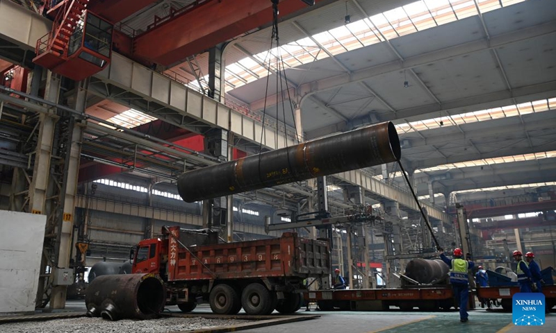 Workers hoist an equipment in a workshop of LS Group High Tech Equipment Industrial Park of Lanzhou New Area in Lanzhou, northwest China's Gansu Province, July 25, 2024. In recent years, Lanzhou New Area has introduced 1,080 high-quality industrial projects with a total investment of 528 billion yuan (about $72.8 billion), and the annual increasing rate of industrial added value has maintained over 50 percent. From 2011 to 2023, the regional GDP of Lanzhou New Area has increased from less than 500 million yuan (about $69 million) to 37.5 billion yuan (about $5.2 billion). Photo: Xinhua