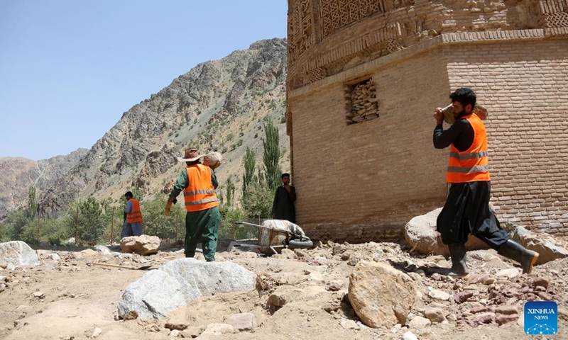 Workers clear stones after a flood near the Minaret of Jam in the Shahrak District, central Afghanistan's Ghor Province, July 28, 2024. The Minaret of Jam, along with its archaeological remains, was inscribed on the World Heritage List by the United Nations Educational, Scientific and Cultural Organization (UNESCO) in 2002. In May, a huge flood hit the province, posing a threat to the minaret, which stands near the Hari River. Photo: Xinhua