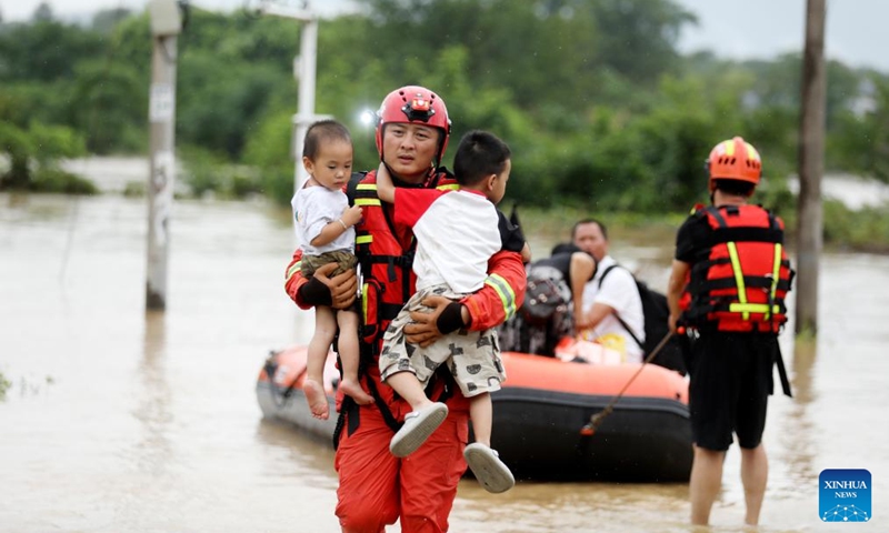 Rescuers relocate residents at Jingtang Village of Zixing City, central China's Hunan Province, July 28, 2024. The residual winds from Typhoon Gaemi continue to bring heavy rains to many places in Hunan Province, and local authorities are actively carrying out rescue and relief work. Photo: Xinhua