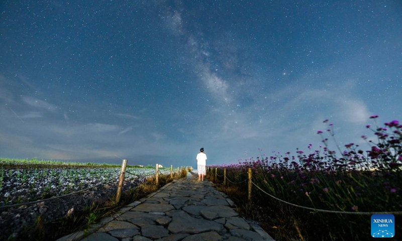 A tourist poses for a photo at the Zimei Lake scenic spot in Jinxing Village, Longshan Town, Longli County, southwest China's Guizhou Province, July 25, 2024. During summer vacation, Longli County has become a popular destination for tourists to escape the sweltering summer heat. In recent years, local authorities have promoted the upgrading of the rural tourism, which attracts more tourists to visit. Photo: Xinhua