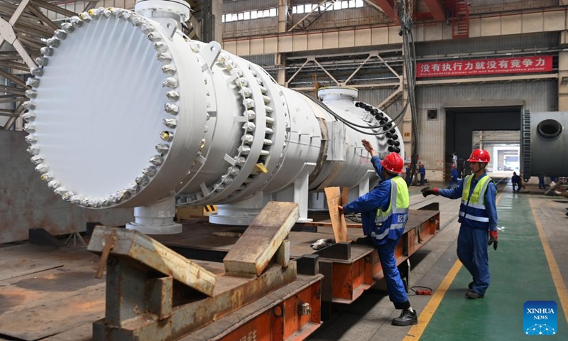 Workers hoist an equipment in a workshop of LS Group High Tech Equipment Industrial Park of Lanzhou New Area in Lanzhou, northwest China's Gansu Province, July 25, 2024. In recent years, Lanzhou New Area has introduced 1,080 high-quality industrial projects with a total investment of 528 billion yuan (about $72.8 billion), and the annual increasing rate of industrial added value has maintained over 50 percent. From 2011 to 2023, the regional GDP of Lanzhou New Area has increased from less than 500 million yuan (about $69 million) to 37.5 billion yuan (about $5.2 billion). Photo: Xinhua