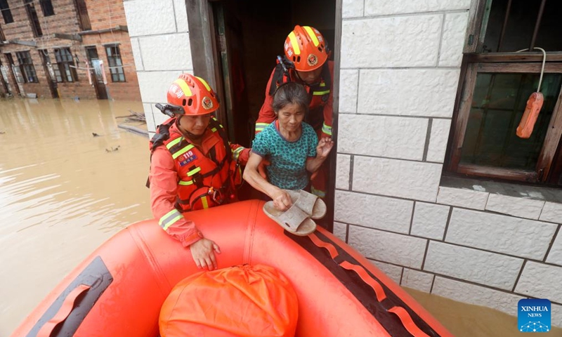 Rescuers relocate a resident at Jingtang Village of Zixing City, central China's Hunan Province, July 28, 2024. The residual winds from Typhoon Gaemi continue to bring heavy rains to many places in Hunan Province, and local authorities are actively carrying out rescue and relief work. Photo: Xinhua