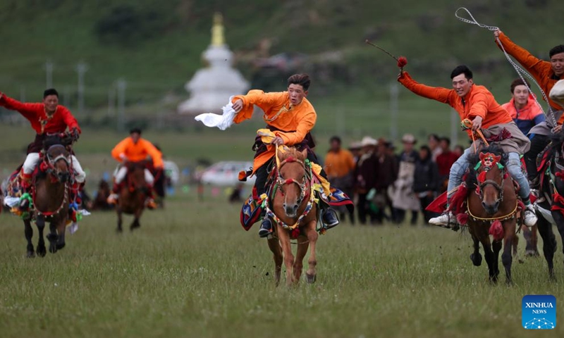 Locals participate in a competition of picking up hada on horseback on a grassland in Baiyu County, Garze Tibetan Autonomous Prefecture, southwest China's Sichuan Province, July 28, 2024. Photo: Xinhua