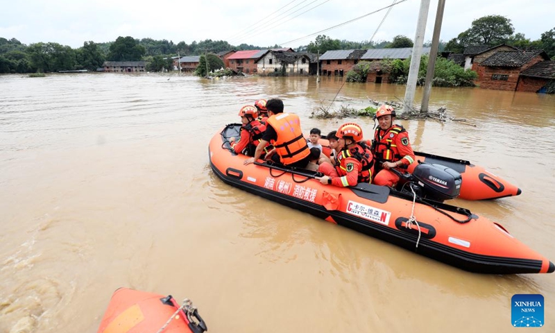 Rescuers relocate residents at Jingtang Village of Zixing City, central China's Hunan Province, July 28, 2024. The residual winds from Typhoon Gaemi continue to bring heavy rains to many places in Hunan Province, and local authorities are actively carrying out rescue and relief work. Photo: Xinhua