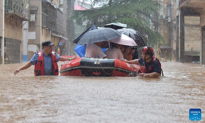 Rescuers and police relocate residents at Shuangfeng County of Loudi City, central China's Hunan Province, July 28, 2024. The residual winds from Typhoon Gaemi continue to bring heavy rains to many places in Hunan Province, and local authorities are actively carrying out rescue and relief work. Photo: Xinhua