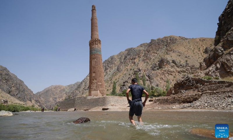 A man cools himself off in the Hari River in the Shahrak District, central Afghanistan's Ghor Province, July 28, 2024. The Minaret of Jam, along with its archaeological remains, was inscribed on the World Heritage List by the United Nations Educational, Scientific and Cultural Organization (UNESCO) in 2002. In May, a huge flood hit the province, posing a threat to the minaret, which stands near the Hari River. Photo: Xinhua