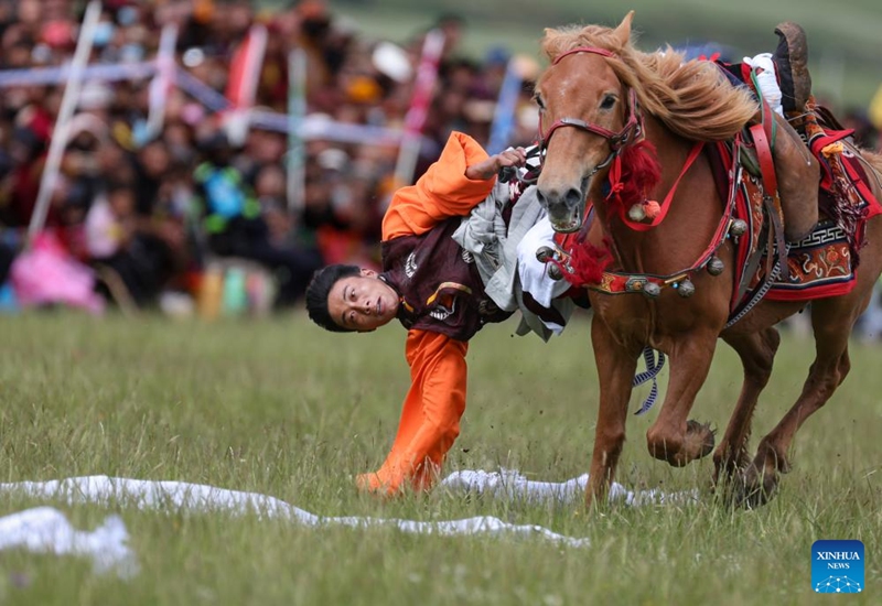 A man participates in a competition of picking up hada on horseback on a grassland in Baiyu County, Garze Tibetan Autonomous Prefecture, southwest China's Sichuan Province, July 28, 2024. Photo: Xinhua