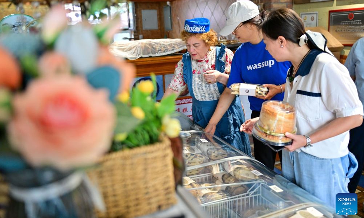 Customers buy traditional Tatar pastries in Tacheng City, northwest China's Xinjiang Uygur Autonomous Region, July 24, 2024.

Xinjiang is experiencing a tourism boom this year. Covering approximately one-sixth of China's land area, Xinjiang boasts diverse and unique natural landscapes, as well as rich historical and cultural tourism resources.(Photo: Xinhua)