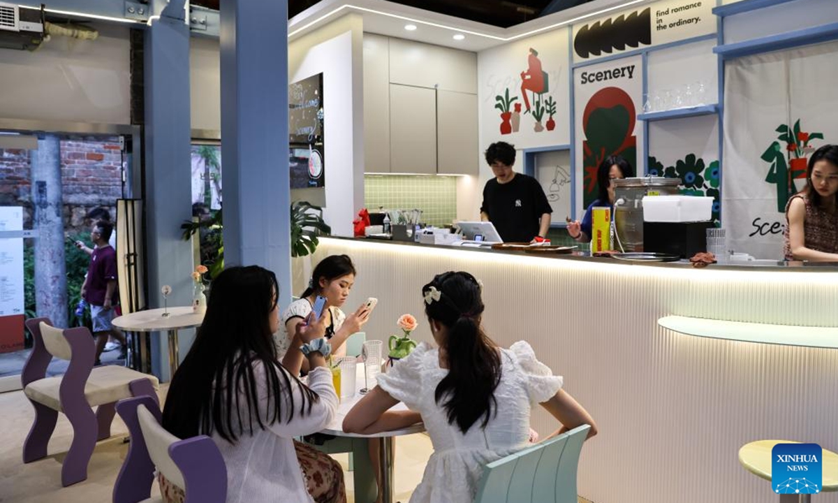 Customers rest at a store on Longmenhao old street in Nan'an District in southwest China's Chongqing Municipality, July 28, 2024. Longmenhao old street, featuring more than 200 ancient architectures built in different forms and periods, was listed in the first batch of urban renewal pilot projects launched by Chongqing. (Photo: Xinhua)