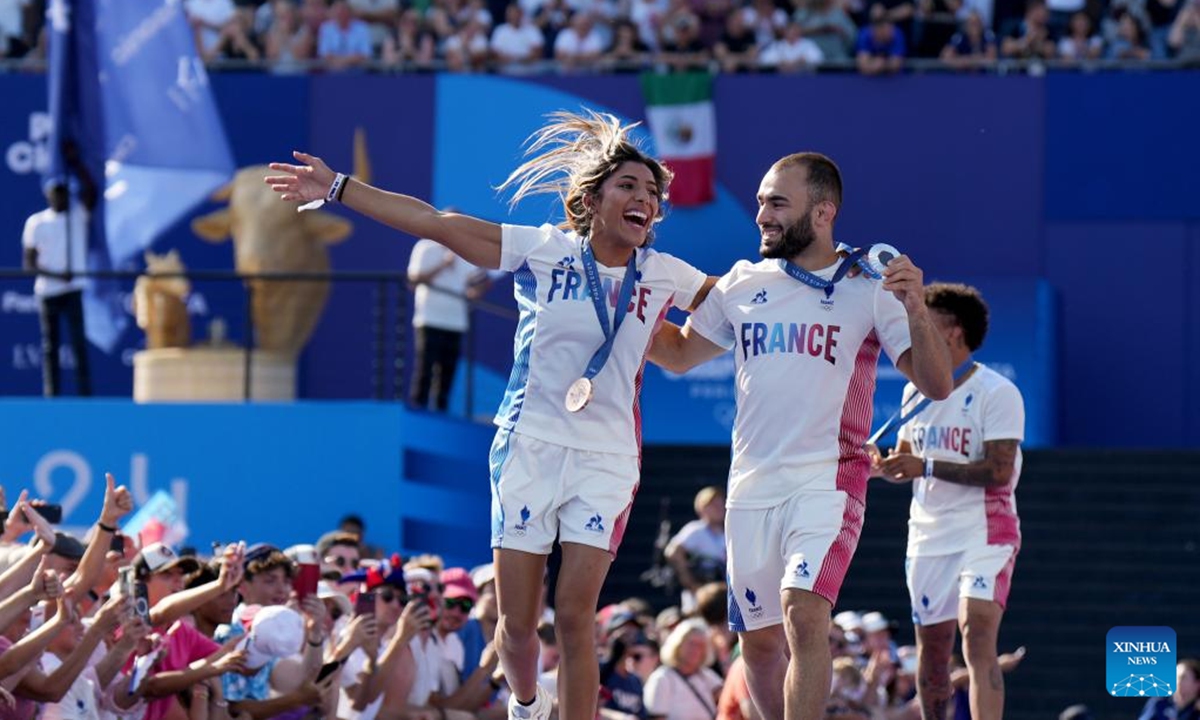 France's judo athletes Shrine Boukli (L) and Luka Mkheidze interact with spectators at Trocadero Champions Park for the Paris 2024 Olympic Games in Paris, France, July 29, 2024. (Photo: Xinhua)