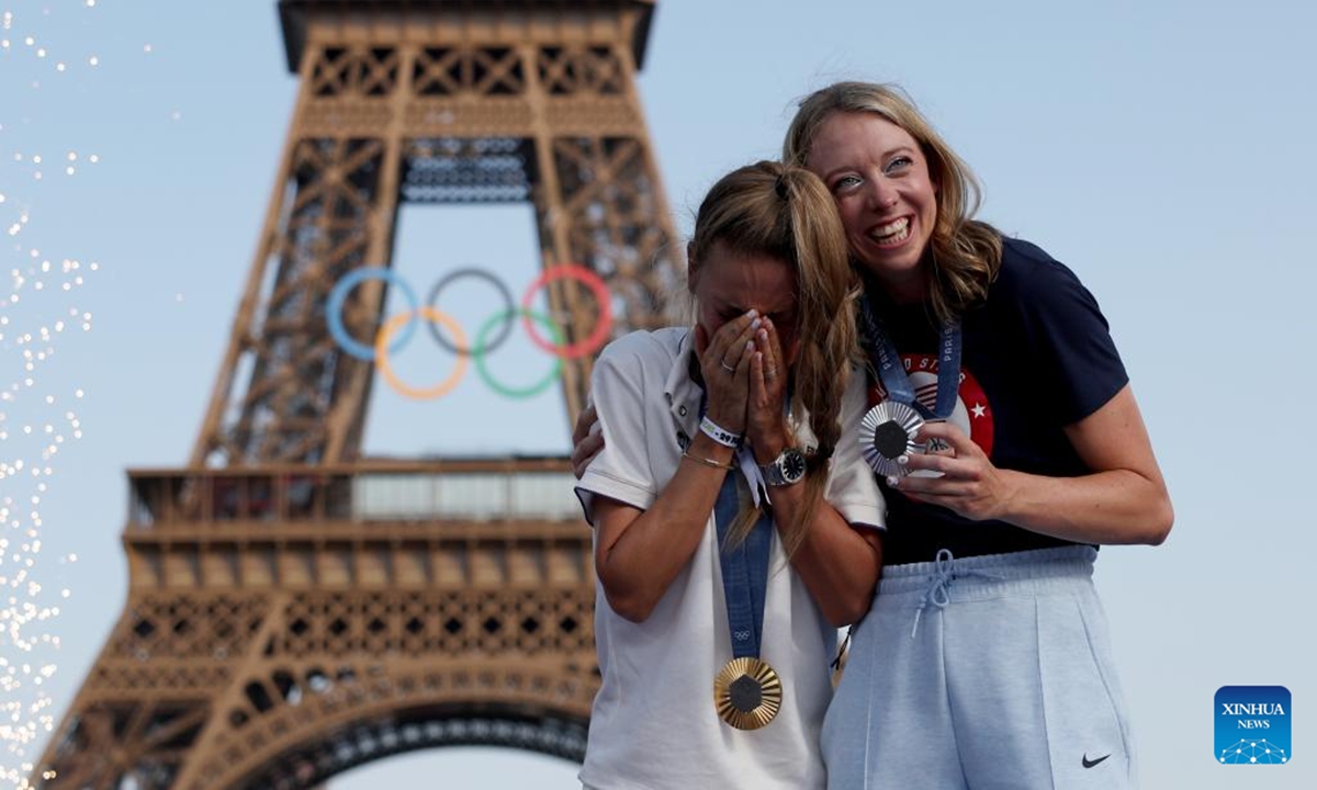 Mountain Bike women's cross-country silver medalist Haley Batten of United States and gold medalist Pauline Ferrand Prevot (L) of France celebrate at Champions Park for the Paris 2024 Olympic Games in Paris, France, July 29, 2024. (Photo: Xinhua)