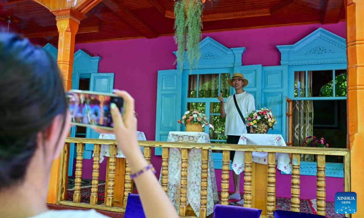 A tourist poses for photos at a homestay in the Kazanqi folk tourism area in Yining City, Ili Kazak Autonomous Prefecture, northwest China's Xinjiang Uygur Autonomous Region, July 27, 2024.

Xinjiang is experiencing a tourism boom this year. Covering approximately one-sixth of China's land area, Xinjiang boasts diverse and unique natural landscapes, as well as rich historical and cultural tourism resources.(Photo: Xinhua)