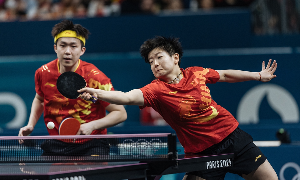 Chinese players Wang Chuqin (left) and Sun Yingsha compete during the table tennis mixed doubles final with Ri Jong-sik and Kim Kum-yong of North Korea at the Paris 2024 Olympic Games in Paris on July 30, 2024. Wang and Sun won the gold medal after beating Ri and Kim 4-2 in the final. This is China's first Olympic gold medal in the table tennis mixed doubles after the mixed doubles made its Olympic debut at Tokyo 2020. Photo: Li Hao/GT