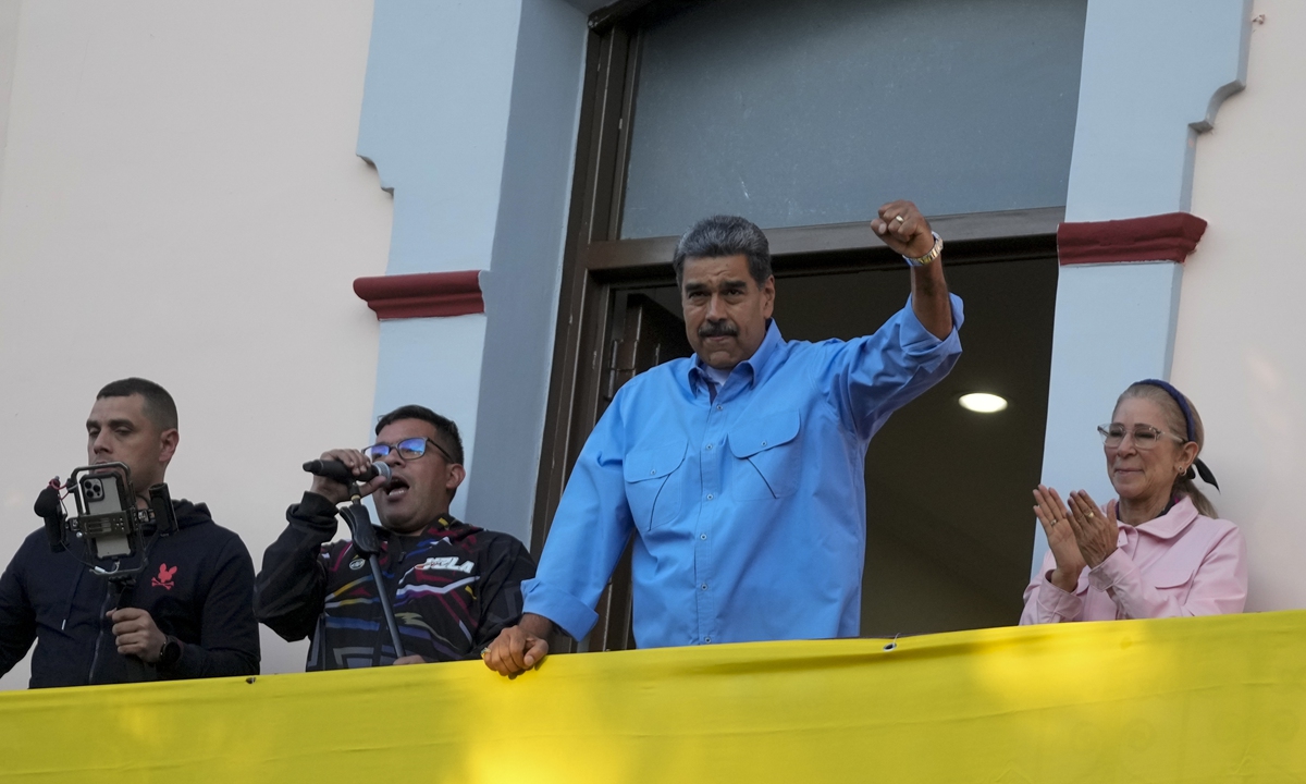 President Nicolas Maduro gestures to supporters during a speech from a balcony in the presidential palace in defense of his <strong></strong>re-election, in Caracas, Venezuela,  on July 30, 2024. Photo: VCG