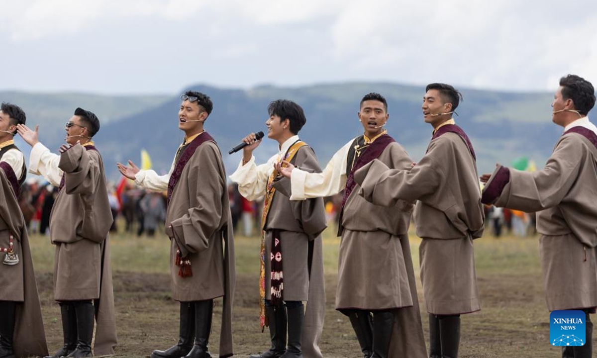 Tamdrin (C) sings with other local singers at a racecourse in Litang County, the Tibetan Autonomous Prefecture of Garze, southwest China's Sichuan Province, July 30, 2024. Tamdrin is a Tibetan herder from a village of Litang County. He became a social media sensation in China years ago and is now the tourism ambassador of his home county of Litang. (Photo: Xinhua)