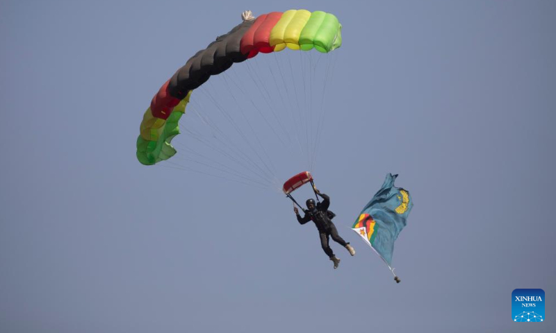 A paratrooper performs during a celebration for the Defense Forces Day in Harare,<strong><a href=