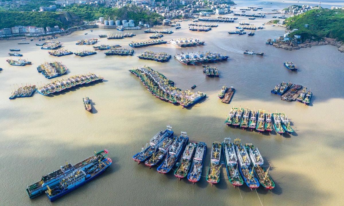 Fishing boats line up at a port in Wenling, East China's Zhejiang Province, on July 31, 2024, to get ready for the beginning of the 