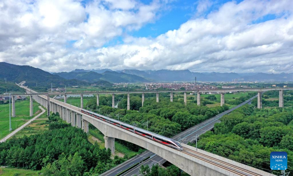 An aerial drone photo taken on July 30, 2024 shows an electrical multiple unit (EMU) train running on the new high-speed railway linking Hangzhou and Wenzhou in Taizhou, east China's Zhejiang Province. A new high-speed railway went into trial operation on Tuesday linking two economic heavyweights of Hangzhou and Wenzhou cities in east China's Yangtze River Delta region. (Photo: Xinhua)